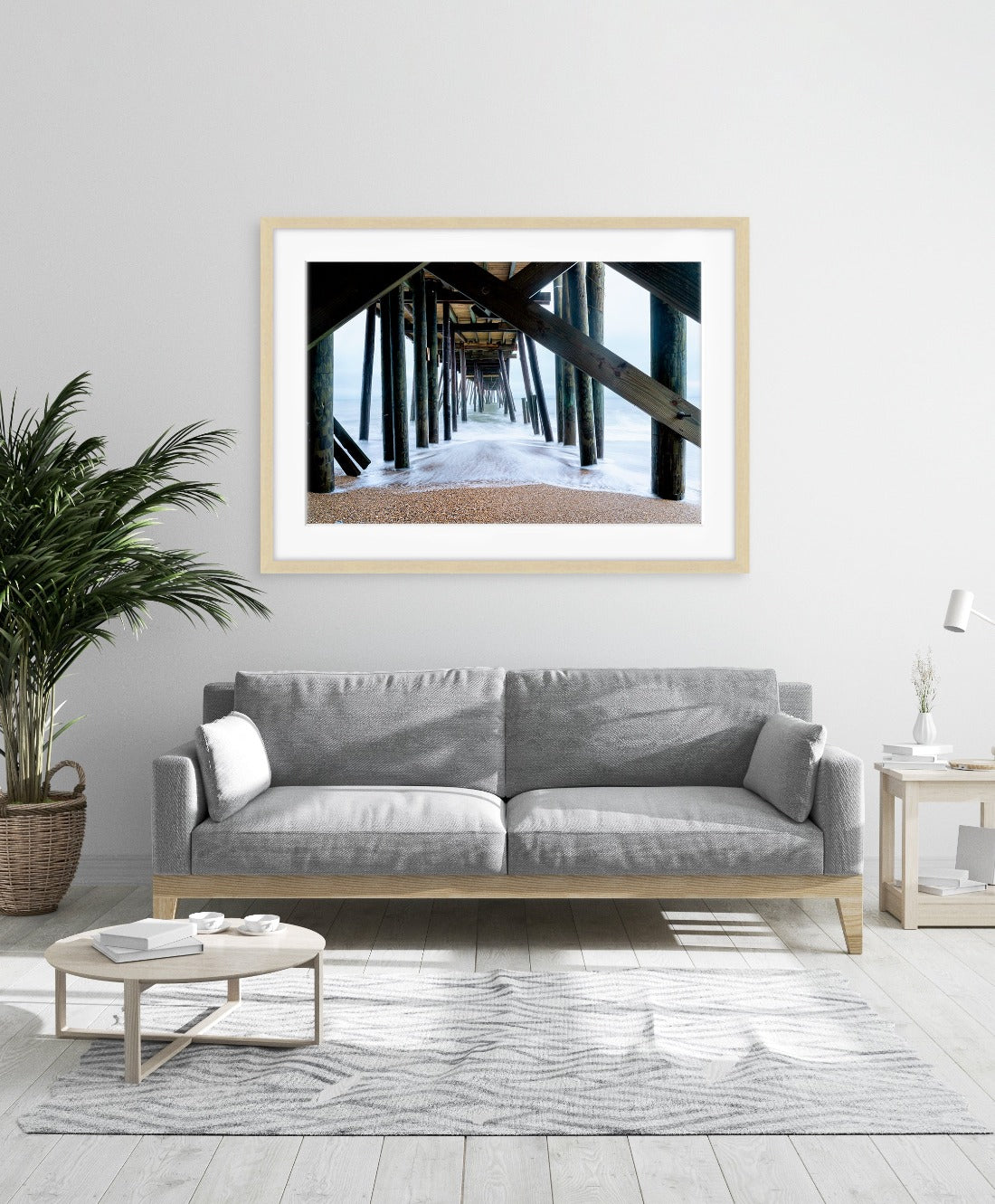 modern living room decor featuring large framed beach wall art by Wright and Roam