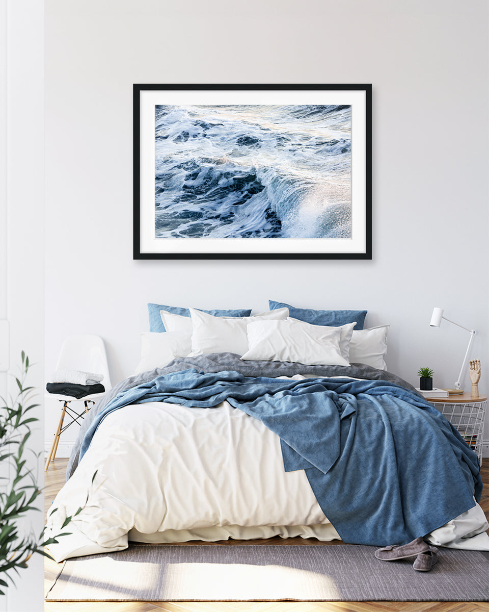 blue bedroom decor with large ocean poster featuring waves