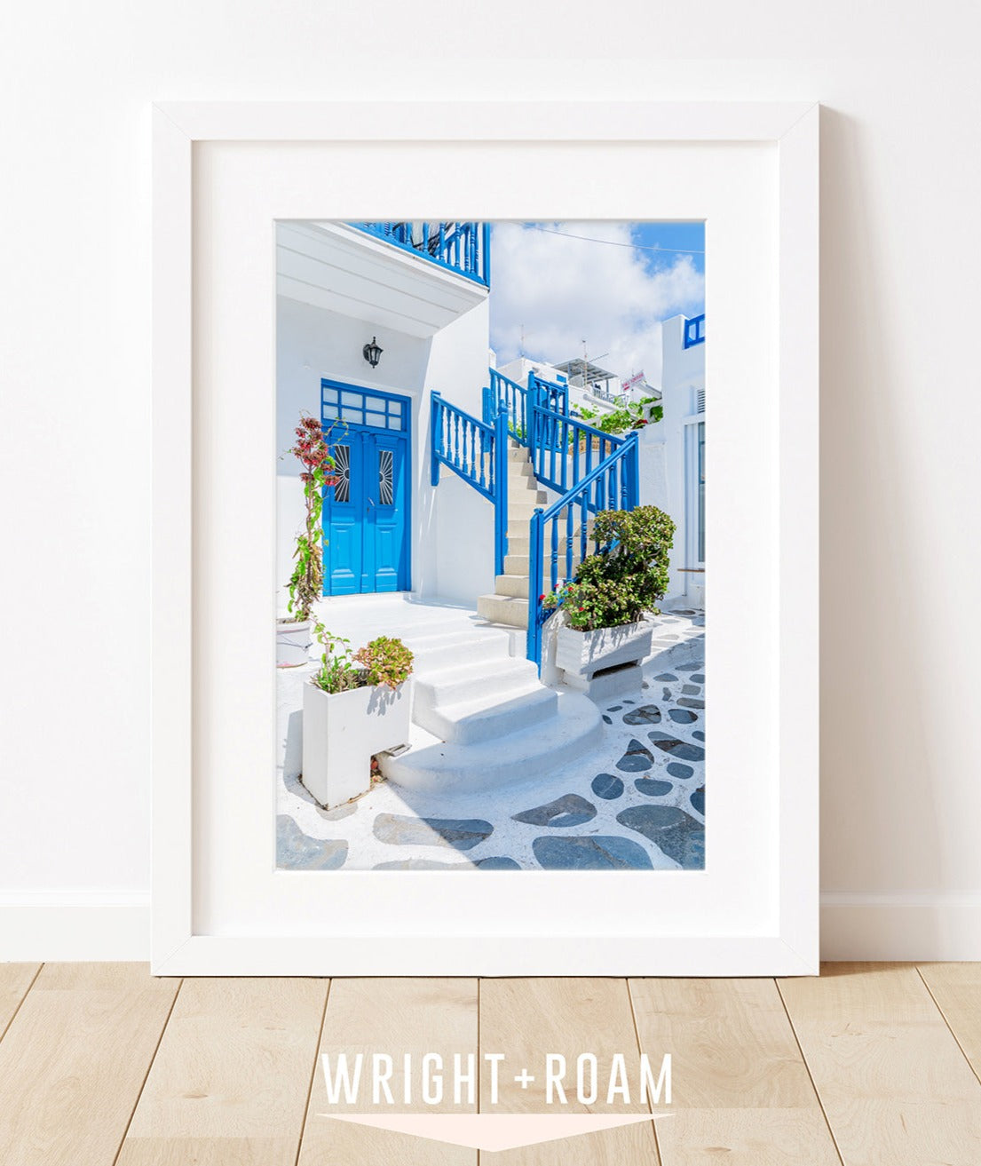 mykonos, greece. featuring blue and white building on grey cobblestone street  