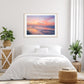 bright white bedroom decor featuring pink colorful sunrise beach photograph by Wright and Roam