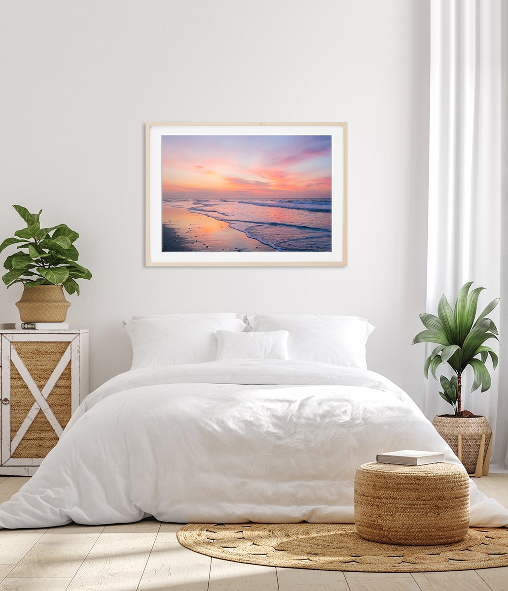 bright white bedroom decor featuring pink colorful sunrise beach photograph by Wright and Roam