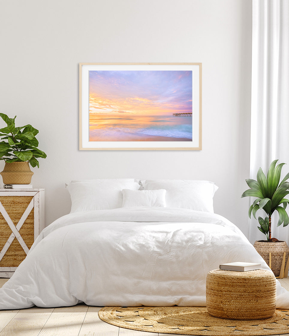 bright white bedroom decor featuring pastel colorful sunrise beach photograph by Wright and Roam