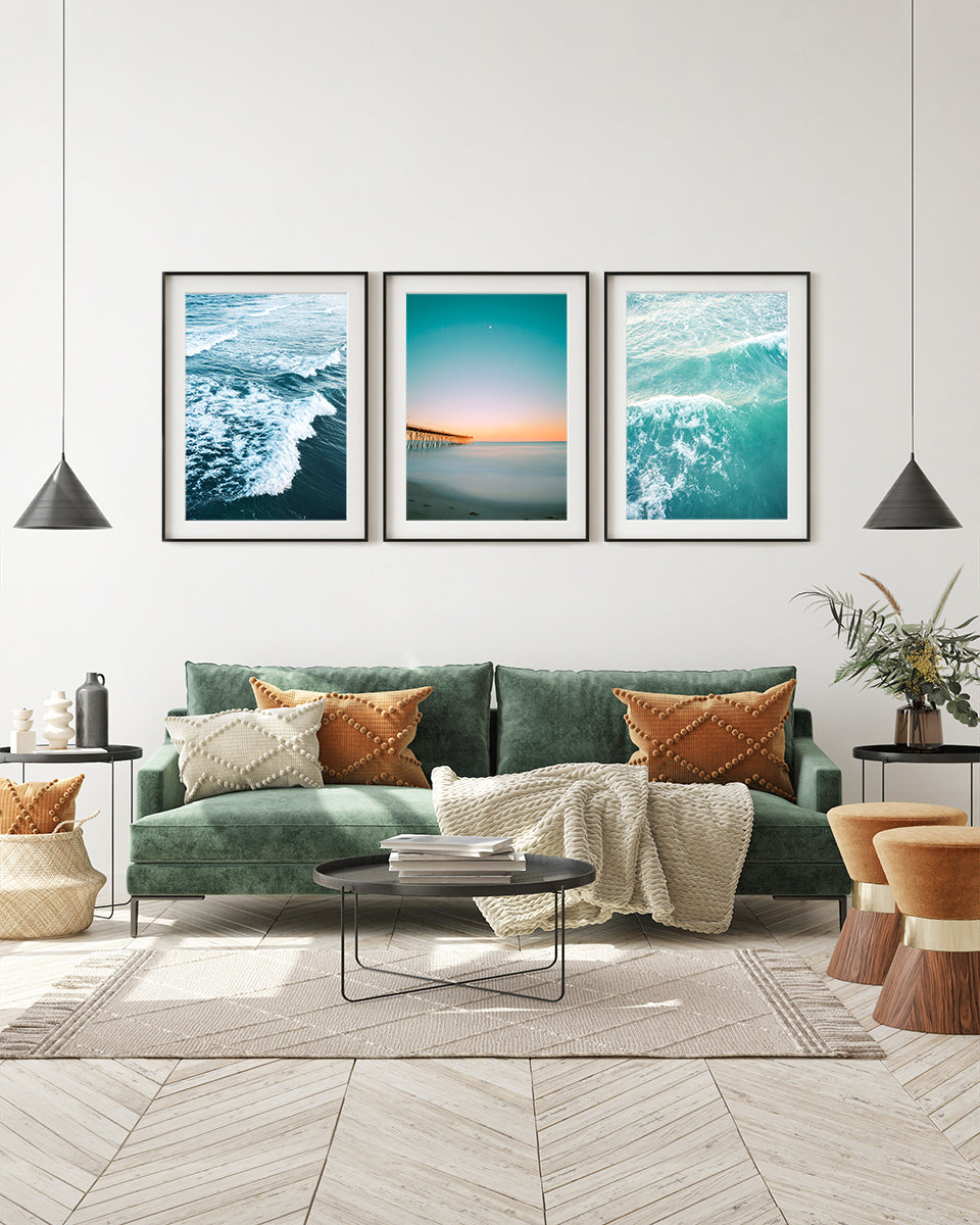 eclectic living room decor, black framed blue beach photographs by Wright and Roam