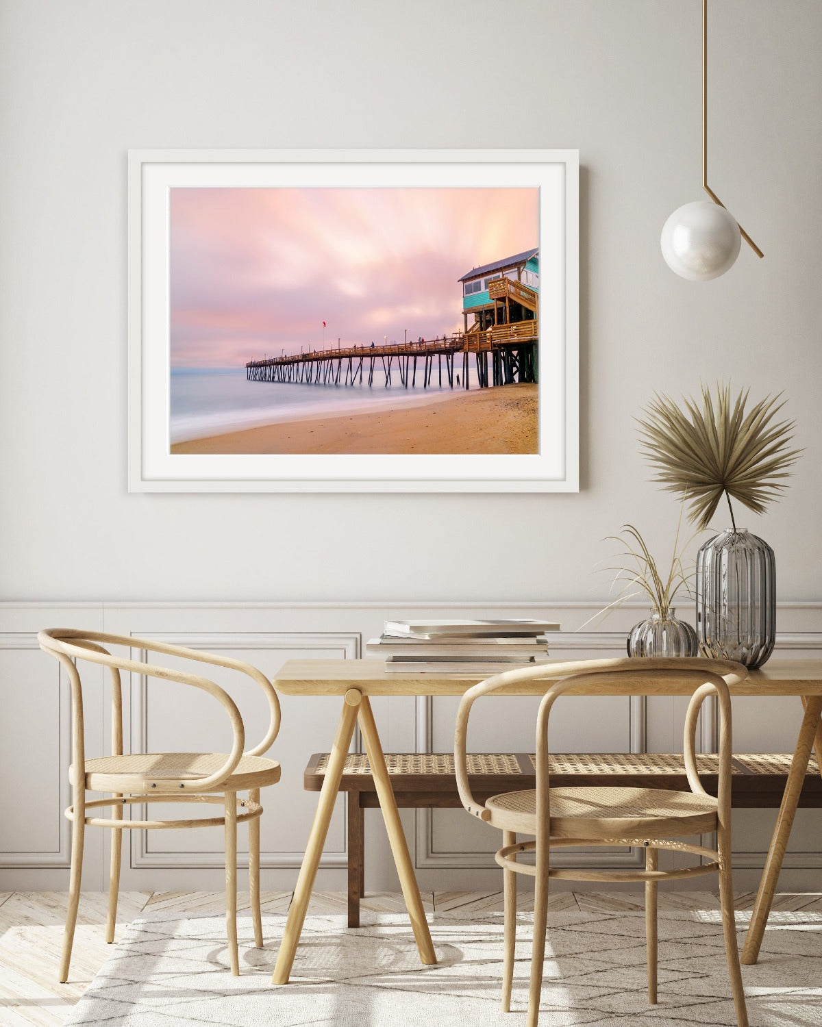 modern dining room decor featuring large framed beach sunrise photography by wright and roam