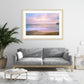 modern living room featuring large framed beach sunrise photograph