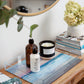 blue ocean print acyrlic serving tray with lotion and candle on entryway