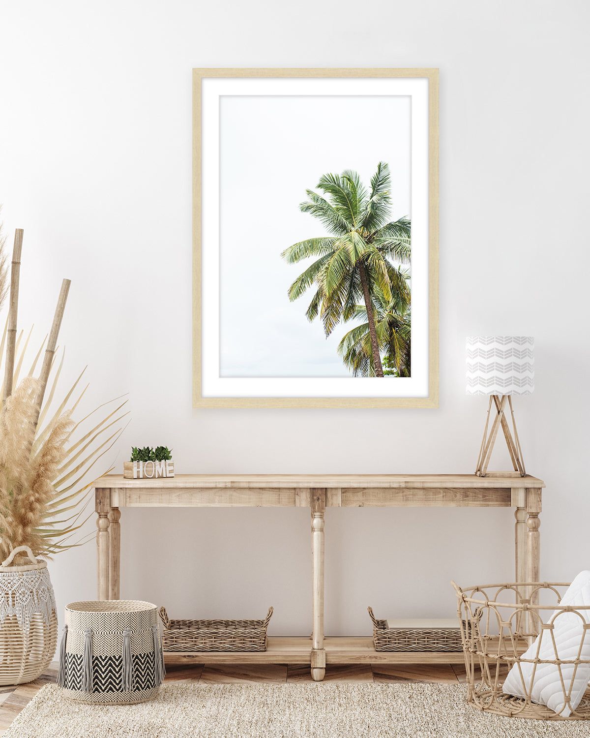 boho, coastal entryway decor featuring large palm tree photograph with wood frame